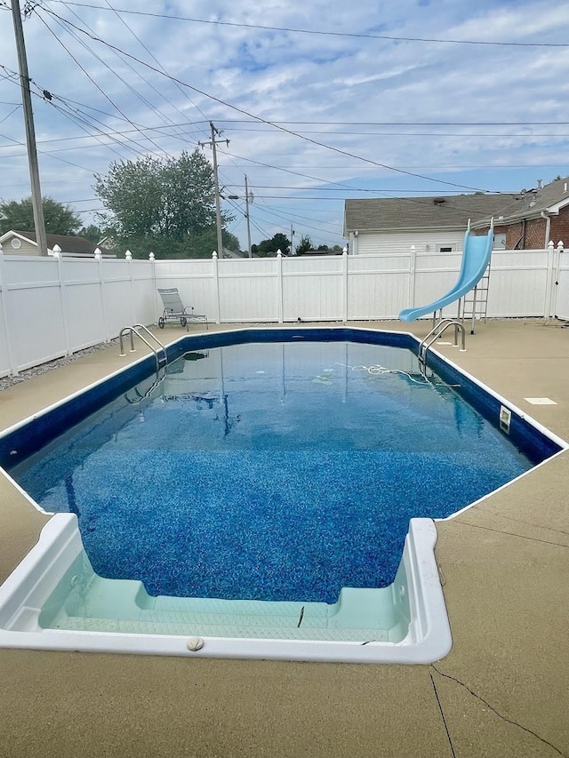 view of pool with a water slide