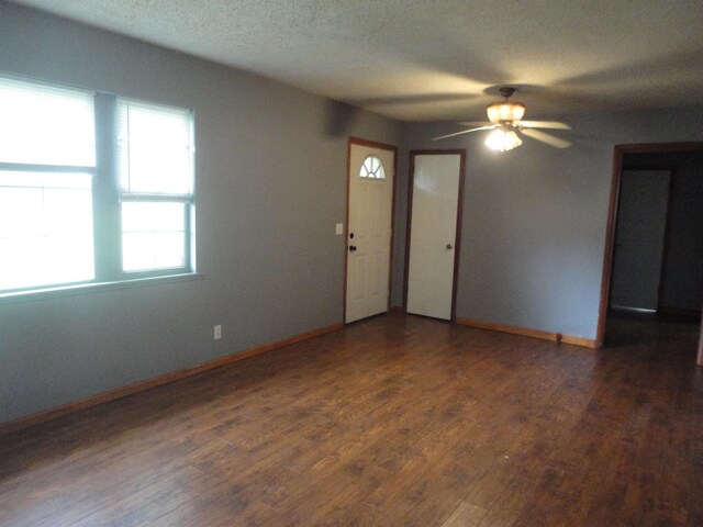  - spare room featuring a ceiling fan, wood finished floors, baseboards, and a textured ceiling