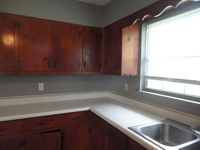  - kitchen with light countertops and a sink