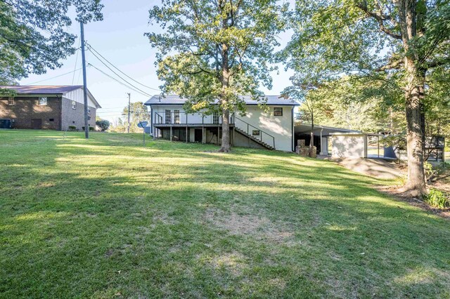 view of yard with a garage and a wooden deck