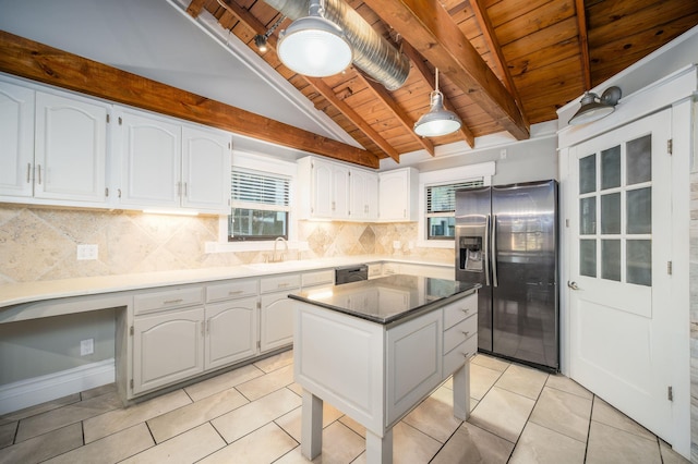 kitchen featuring white cabinetry, lofted ceiling with beams, stainless steel refrigerator with ice dispenser, a kitchen island, and wood ceiling