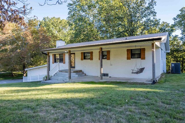 view of front of property with cooling unit and a front lawn