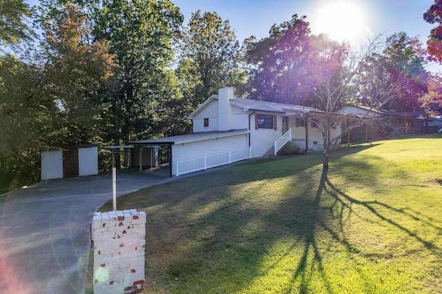 view of front of property with a carport and a front lawn