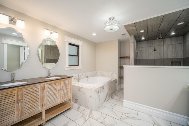 bathroom featuring vanity and shower with separate bathtub