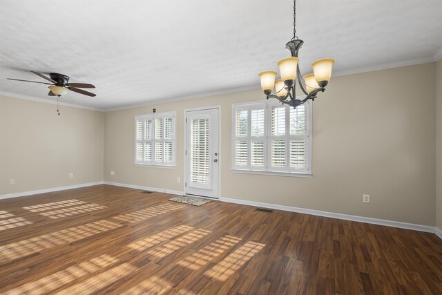 empty room featuring crown molding, dark wood-type flooring, and ceiling fan with notable chandelier