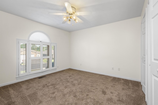 empty room with ceiling fan and carpet floors