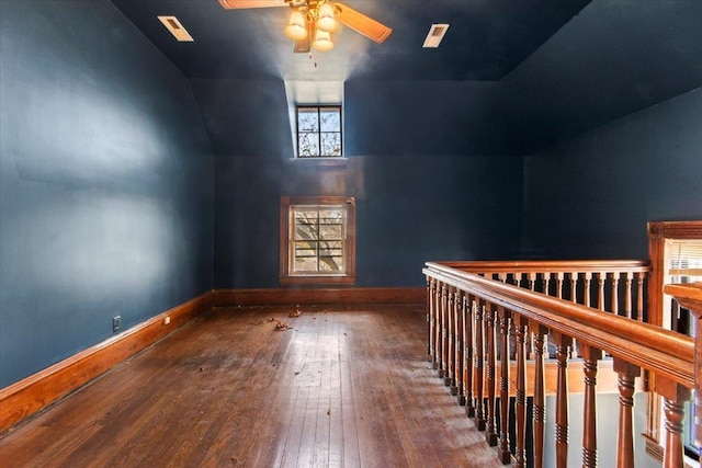 additional living space featuring lofted ceiling, hardwood / wood-style floors, and ceiling fan