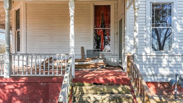 view of exterior entry featuring covered porch