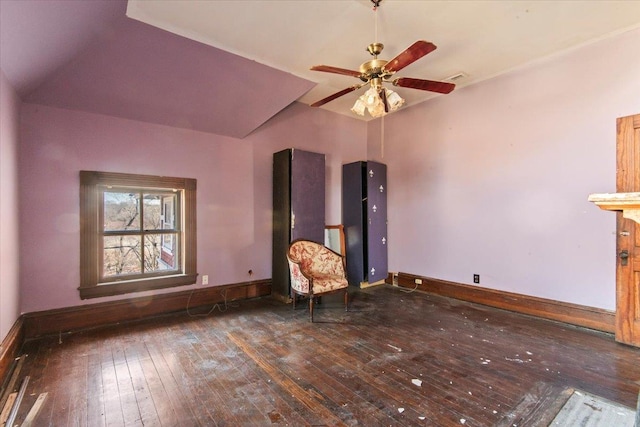 unfurnished room featuring dark hardwood / wood-style flooring, vaulted ceiling, and ceiling fan