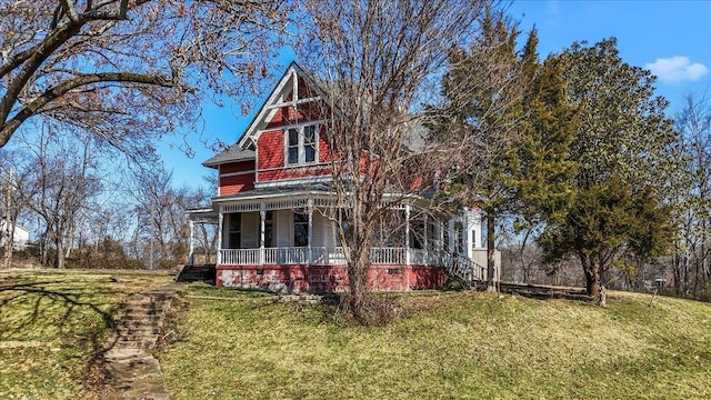 view of front of home with a porch and a front yard