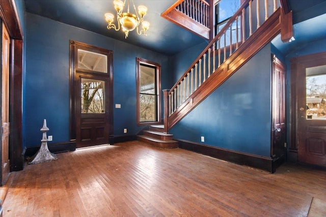 entryway featuring hardwood / wood-style flooring and a chandelier