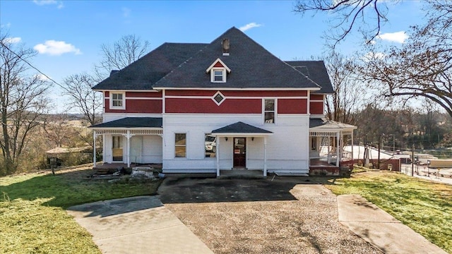 view of front of house with a porch and a front lawn