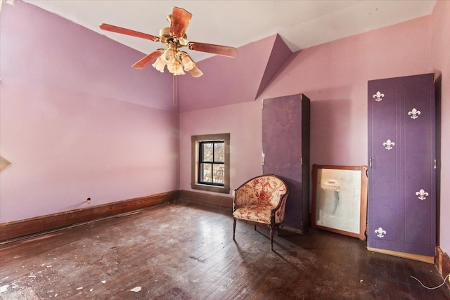 unfurnished room featuring vaulted ceiling, dark hardwood / wood-style floors, and ceiling fan