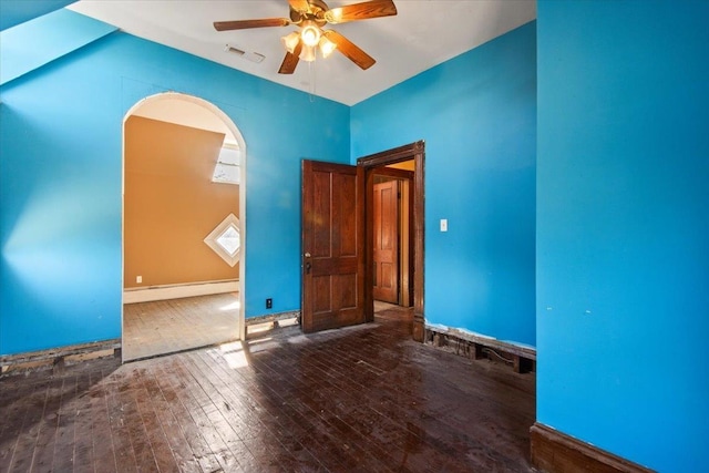 unfurnished room featuring hardwood / wood-style flooring, ceiling fan, and baseboard heating