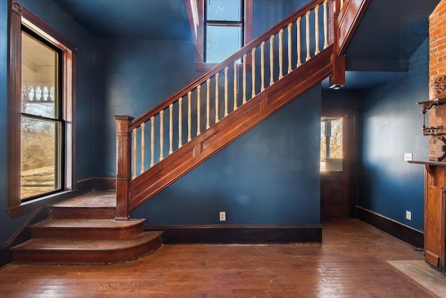 stairway featuring hardwood / wood-style flooring and a wealth of natural light