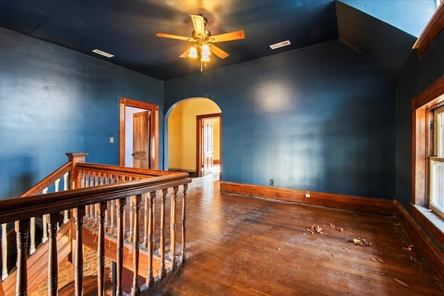 unfurnished room featuring hardwood / wood-style flooring, ceiling fan, and a skylight