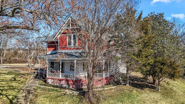 exterior space with a front yard and covered porch