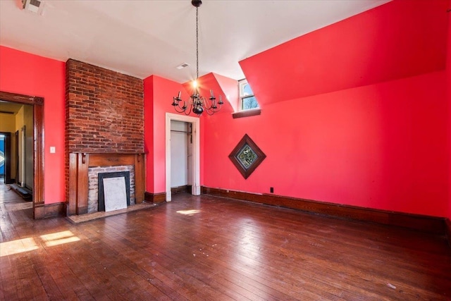 unfurnished living room featuring dark hardwood / wood-style floors and a notable chandelier