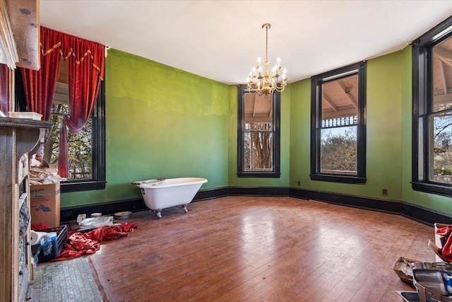 empty room with an inviting chandelier and hardwood / wood-style floors