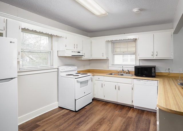 kitchen featuring white cabinetry, sink, and white appliances