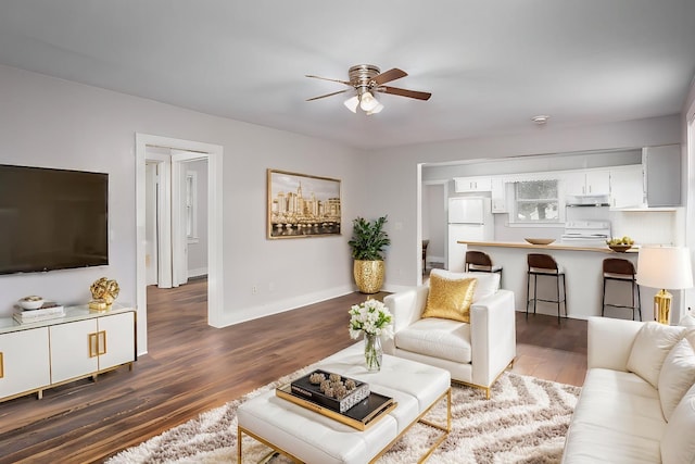 living room featuring dark hardwood / wood-style floors and ceiling fan