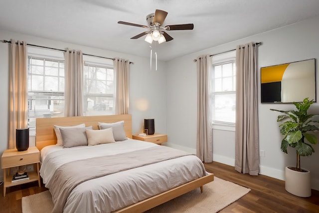 bedroom with dark hardwood / wood-style floors and ceiling fan