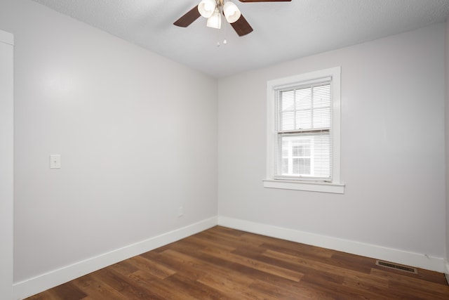 unfurnished room featuring ceiling fan, dark hardwood / wood-style flooring, and a textured ceiling