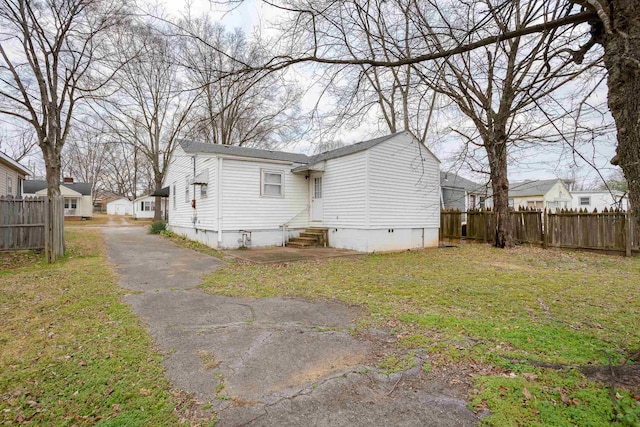 back of property featuring a lawn