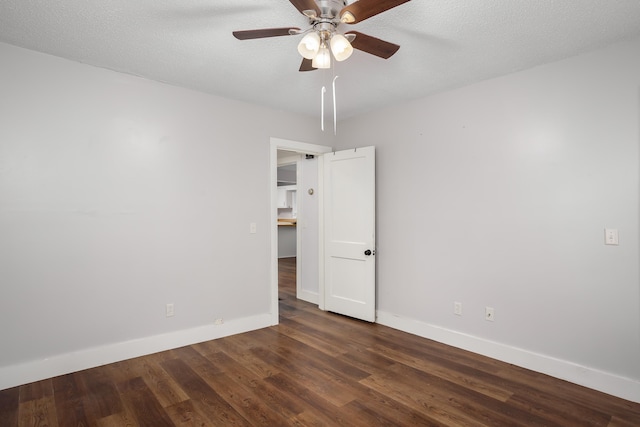 unfurnished room with dark wood-type flooring, a textured ceiling, and ceiling fan