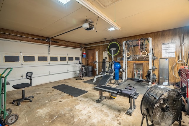  - garage featuring a garage door opener and wood walls