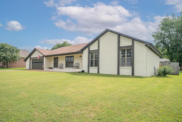  - view of front of home with an attached garage and a front yard