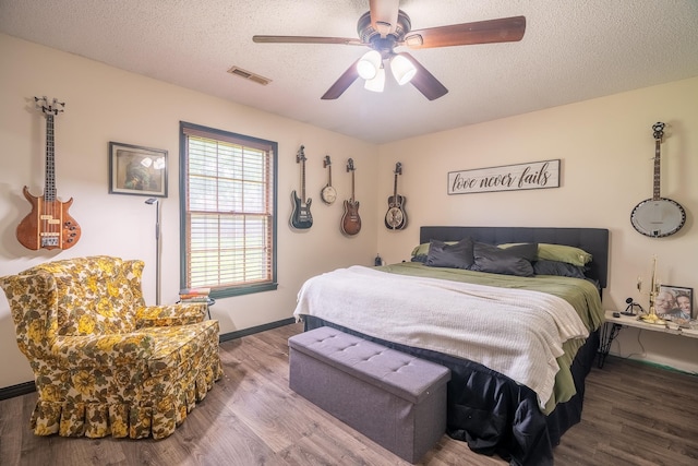  - bedroom featuring wood finished floors, a textured ceiling, and ceiling fan