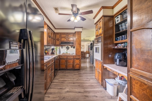 - kitchen with refrigerator with ice dispenser, crown molding, a ceiling fan, dishwashing machine, and dark wood finished floors
