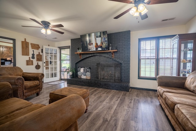 - living area with ceiling fan, wood finished floors, and a fireplace