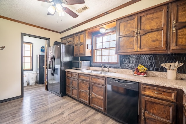  - kitchen featuring black appliances, light wood-style flooring, light countertops, a ceiling fan, and healthy amount of natural light