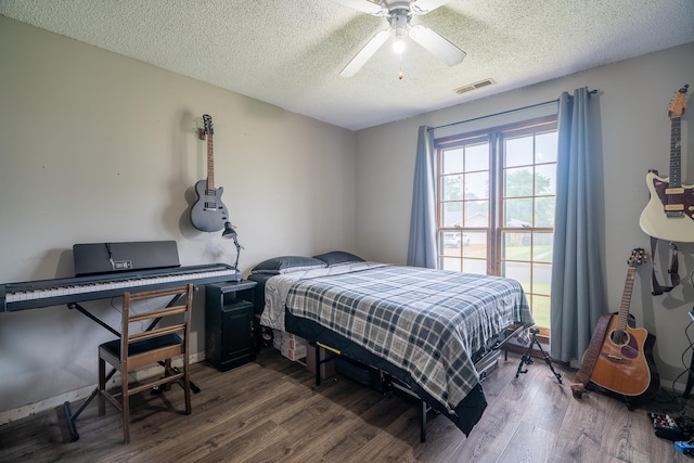  - bedroom with wood finished floors, a textured ceiling, and a ceiling fan