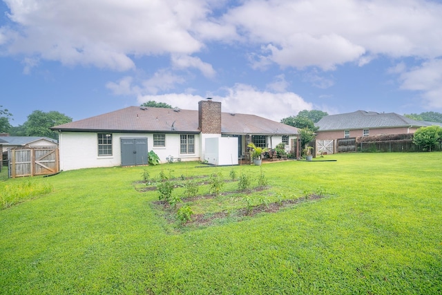  - rear view of property with a fenced backyard, a chimney, a gate, and a storage unit