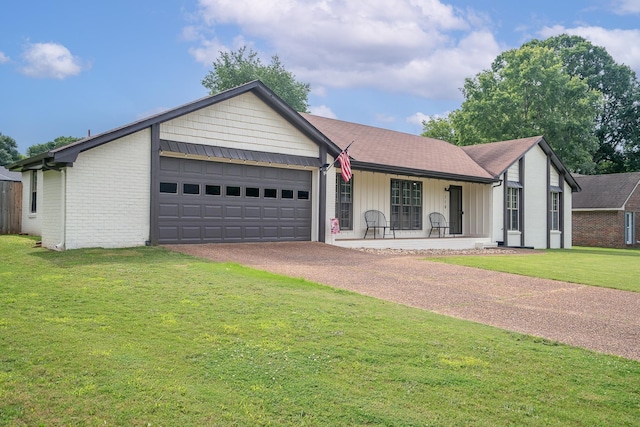  - ranch-style house with a garage, driveway, a front yard, and board and batten siding