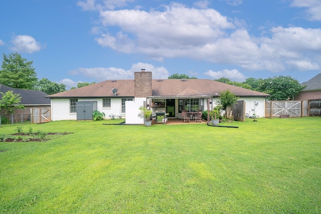  - back of property featuring a gate, a patio, a fenced backyard, and a chimney