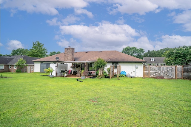  - back of house with a patio area, a fenced backyard, a chimney, and a gate