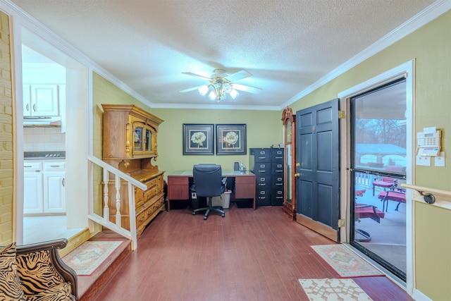 office space with ornamental molding, dark wood-type flooring, ceiling fan, and a textured ceiling