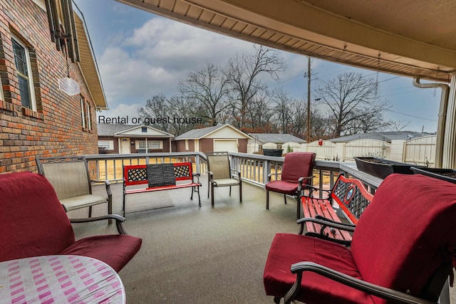 view of patio with an outbuilding, an outdoor living space, and a garage