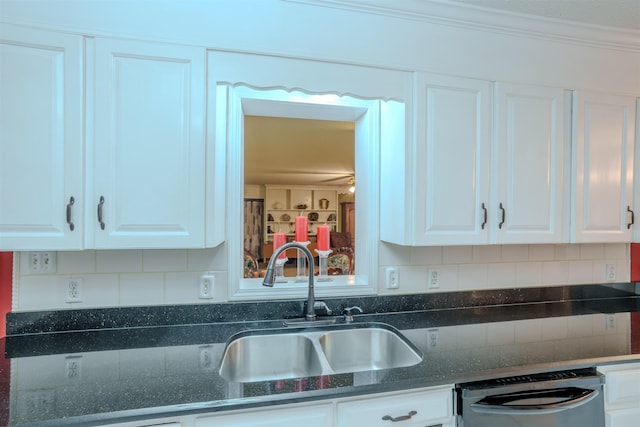 kitchen with white cabinetry, sink, stainless steel dishwasher, and crown molding