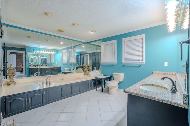 bathroom with ornamental molding, vanity, and a textured ceiling