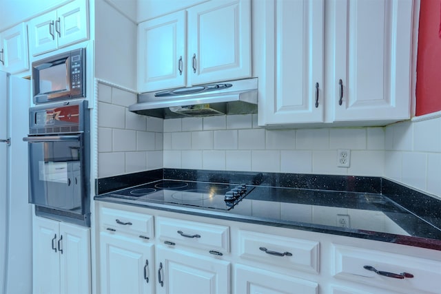 kitchen with white cabinets, decorative backsplash, and black appliances