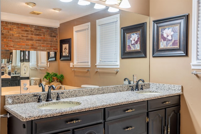 bathroom featuring crown molding, vanity, and toilet