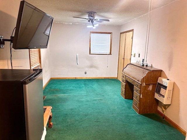 interior space with ceiling fan, dark carpet, a textured ceiling, and heating unit