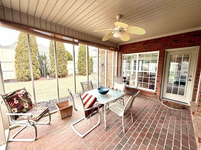 sunroom / solarium with wood ceiling and ceiling fan