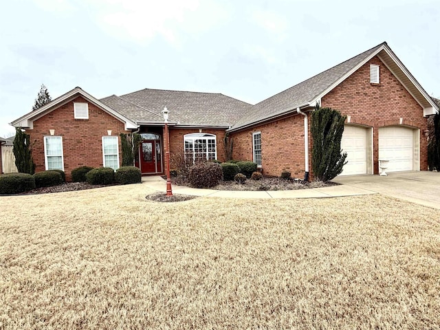 - ranch-style home with a garage and a front lawn