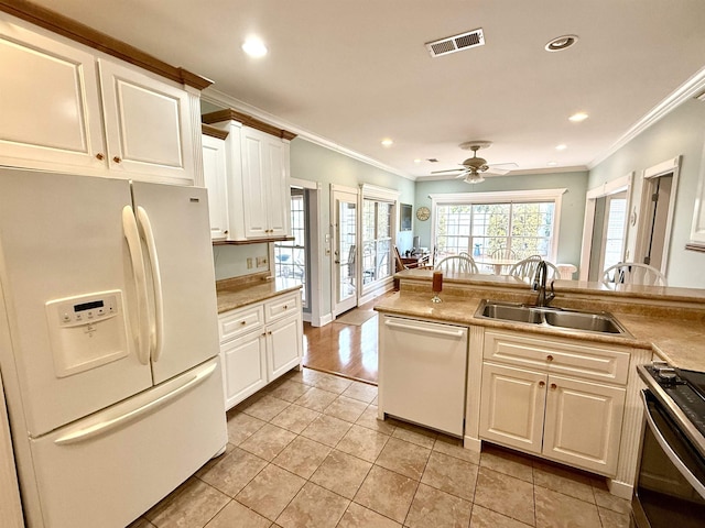 kitchen featuring sink, white cabinets, ornamental molding, light tile patterned floors, and white appliances